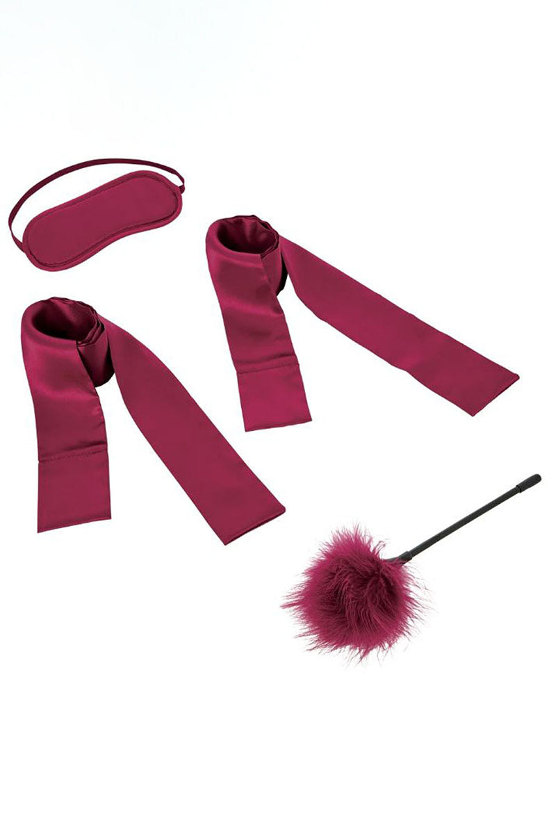 Burgundy satin kit: oval blindfold, two long satin tether ribbons, and a burgundy feather tickler with black handle.