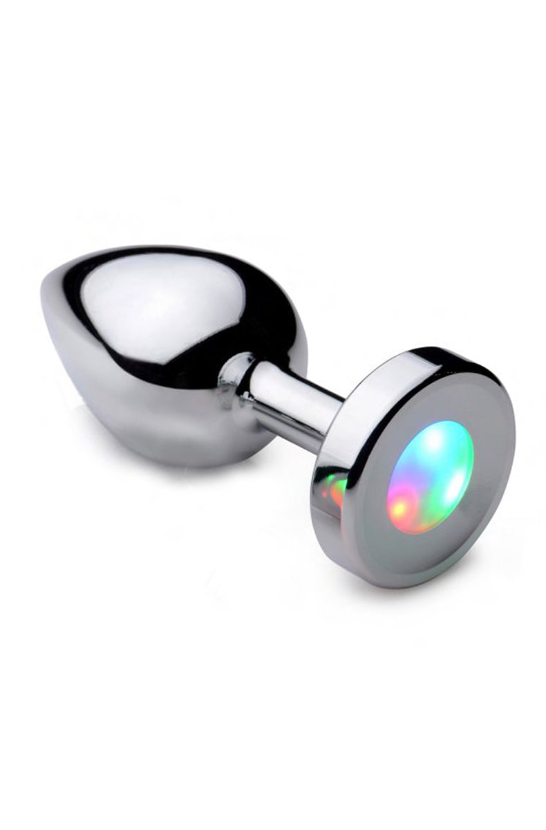 Booty Sparks Light Up Large Anal Plug in polished silver alloy with a round flared base and lit rainbow LED disk.