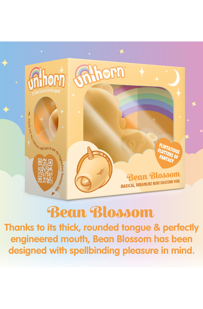 Side view of the yellow silicone Unihorn Bean Blossom vibrator showing the unicorn's horn and curled body.